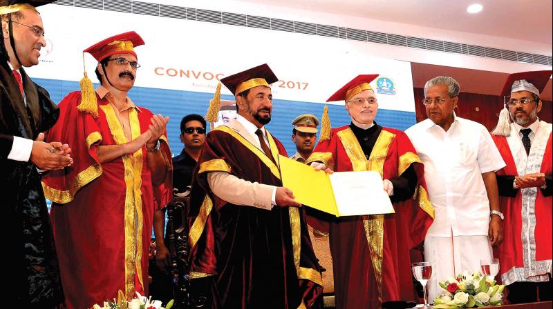 Kerala Governor and Chancellor of Calicut University P. Sathasivam confers the D Litt by Calicut University on the UAE Supreme Council member and Sharjah ruler Sheikh Sultan Bin Muhammed Al Qasimi at a function in Raj Bhavan on Tuesday. Calicut University registrar Dr T.A. Abdul Majeed, pro-chancellor and education minister C. Raveendranath, Chief minister Pinarayi Vijayan  and vice-chancellor Dr K. Mohammed Basheer, pro vice-chancellor Dr P. Mohan look on. (Photo: DC)