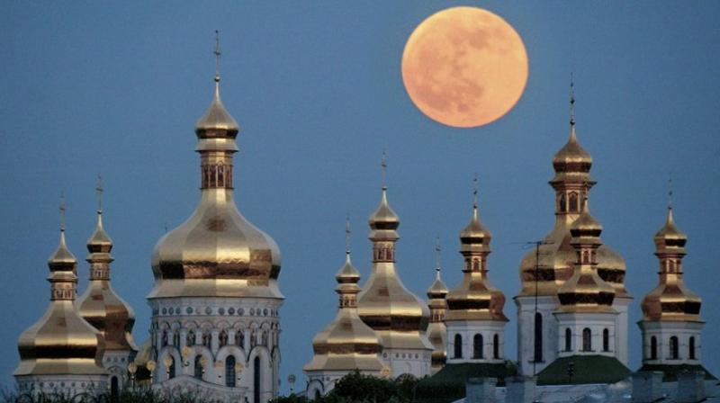 A full moon rises above the golden domes of the Orthodox Monastery of the Caves in Kiev, Ukraine. Ukraine is lobbying hard for a religious divorce from Russia and some observers say the issue could be decided as soon as September 2018. (AP Photo/Efrem Lukatsky, File)