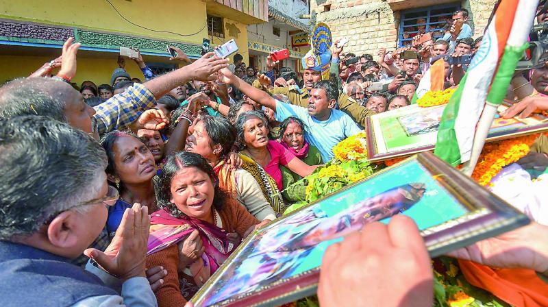 Family members of slain CRPF jawan Sanjay Kumar Singh pay their last respects before his funeral procession, at Masaurhi, in Patna on Saturday.  (PTI)