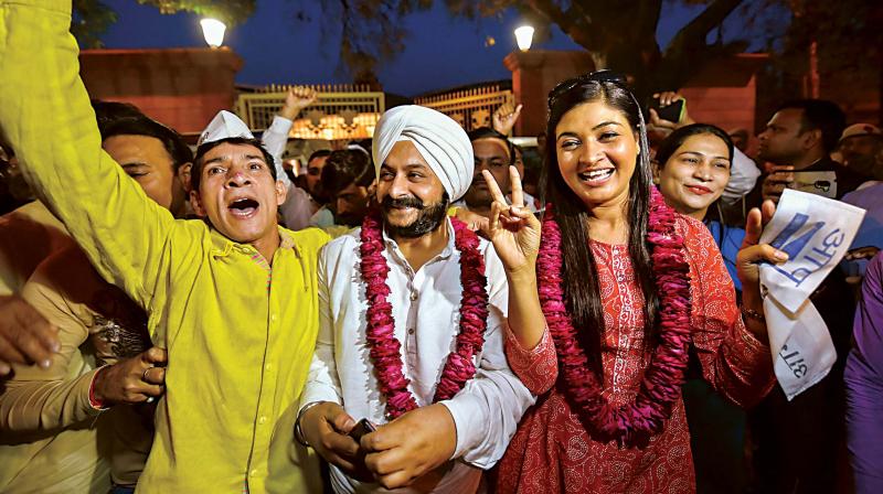 AAP MLAs Jarnail Singh and Alka Lamba celebrating the judgment of Delhi High Court outside Delhi CM Arvind Kejriwals residence in New Delhi, on Friday 	 PTI