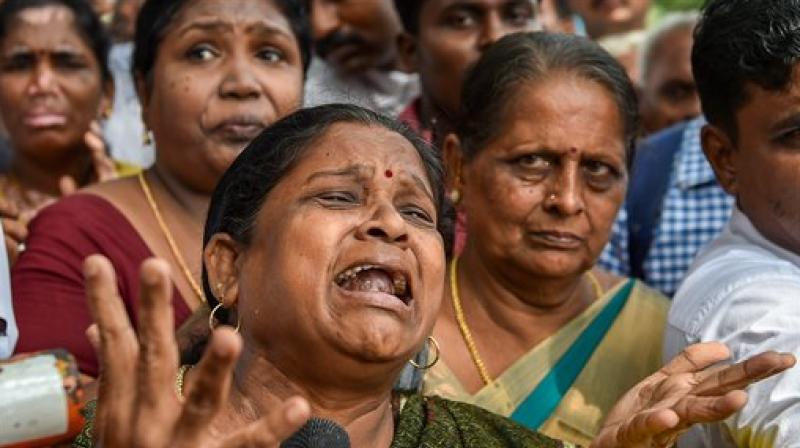 DMK supporters outside the hospital, where DMK president M Karunanidhi is being treated for fever due to urinary tract infection. (Photo: PTI)