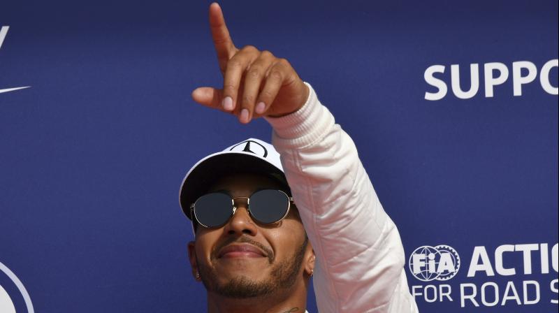 Lewis Hamilton celebrates after grabbing pole posittion. (Photo: AP)