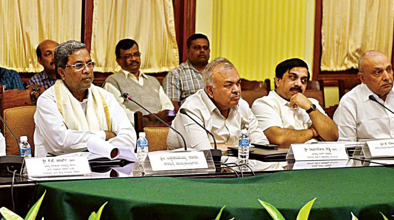 Chief Minister Siddaramaiah flanked by ministers K.J. George and Ramalinga Reddy at a meeting of Bengaluru Metropolitan Project Committee in Bengaluru on Friday KPN