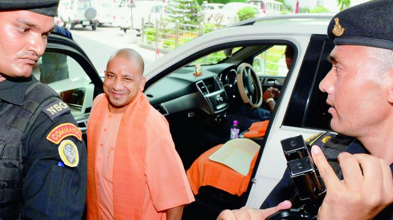 UP Chief Minister Yogi Adityanath arrives at his office without the red beacon vehicle in Lucknow on Friday. (Photo: PTI)