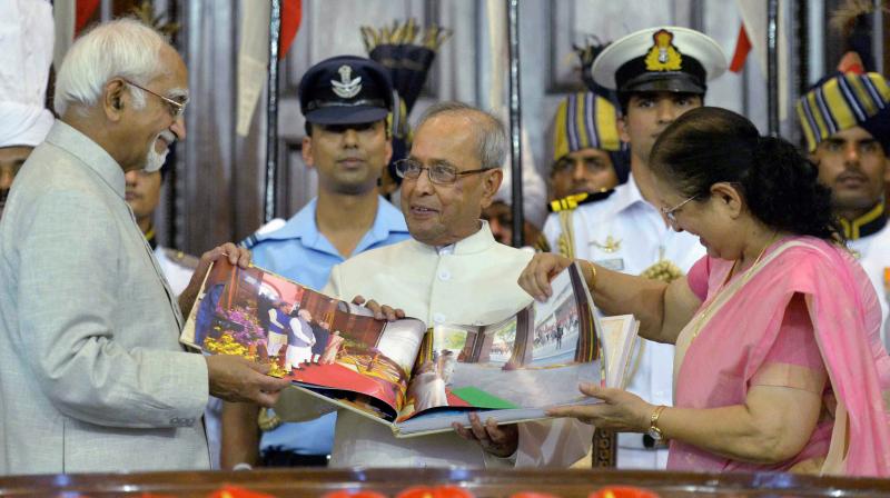 President Pranab Mukherjee is presented a coffee-table book by Vice President Hamid Ansari and Lok Sabha Speaker Sumitra Mahajan during his farewell ceremony in the Central Hall of Parliament in New Delhi on Sunday. (Photo: PTI)