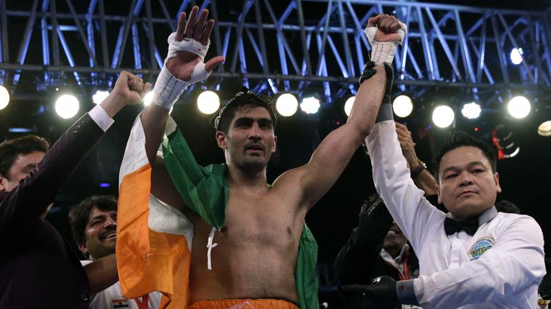 Indian boxing and WBO Asia-Pacific Super Middleweight champion Vijender Singh celebrates after winning the double title against WBO Oriental Super Middleweight champion of China Zulpikar Maimaitiali in Mumbai (Photo:AP)