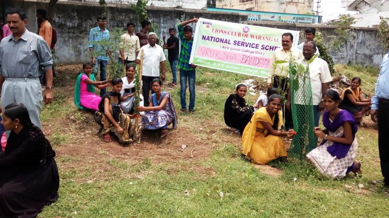 Girl students of AVV junior college tying rakhi to the sapling they had adopted on Wednesday at Waranagal. (Photo: DC)