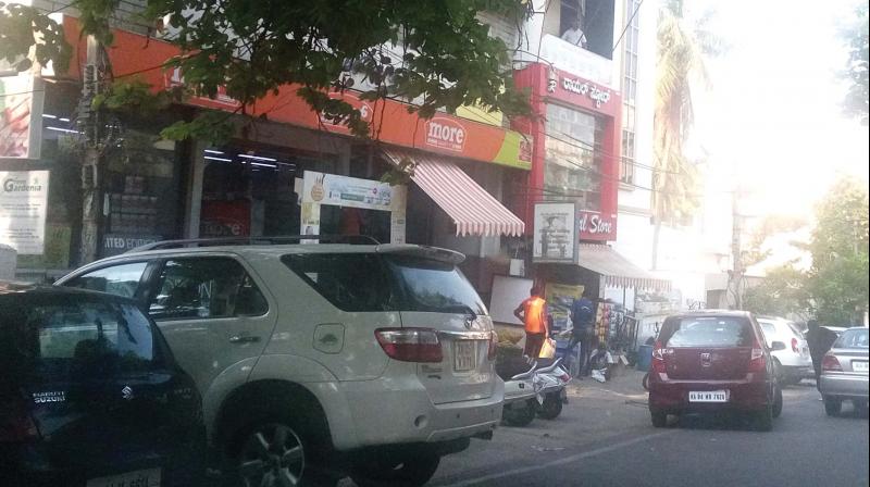 Vehicles parked in a haphazard manner on Nandidurga 1st Main Road. (Photo: DC)