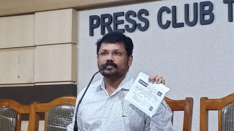 Badushah N.S. of Nattika shows the documents of the alleged money laundering before the media in Thrissur on Thursday.