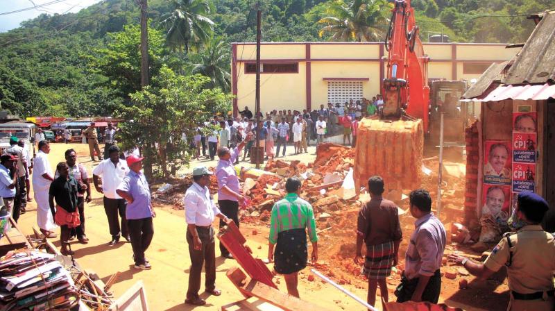 Officials monitor the demolition of shops at Kazhuthurtty junction for gauge conversion works. (Photo:  DC)