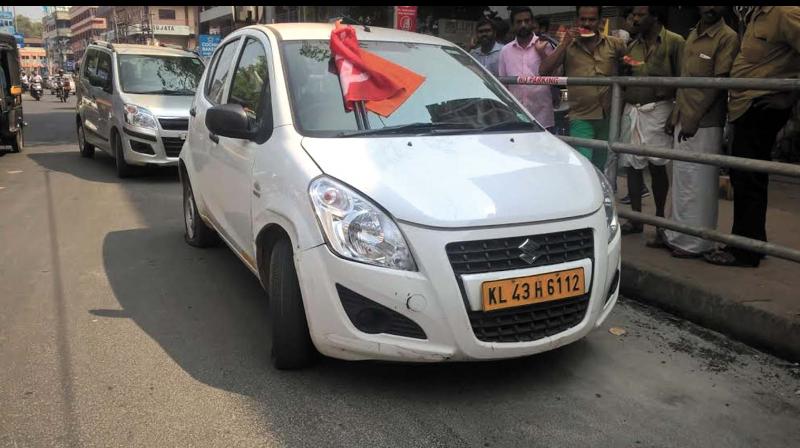 A Mango Taxi cab with the union flags placed on it by CITU, BMS workers on Friday. (Photo: DC)