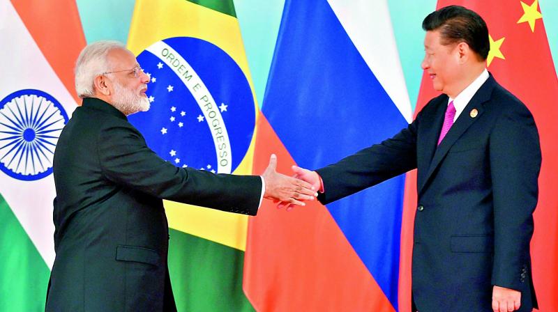 Prime Minister Narendra Modi and Chinese President Xi Jinping shake hands before the group photo session at 2017 Brics Summit in Xiamen, Fujian province in China, on Monday. (Photo: PTI)