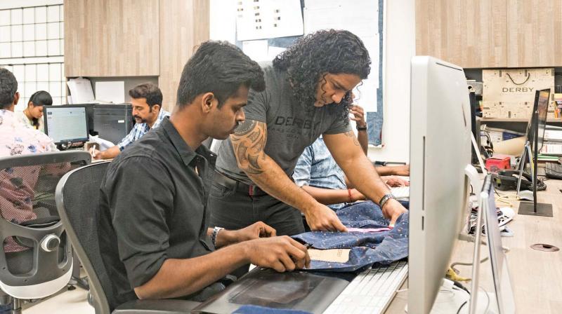 Vijay Kapoor in his workplace takes measurements of jeans in his quest for perfection.