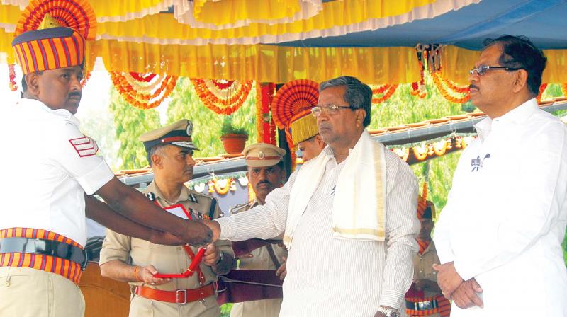 Chief Minister Siddaramaiah and Home Minister Dr.G.Parameshwar during the Police Flag Day at KSRP Ground in Koramangala in the city on Sunday.(Photo: DC)
