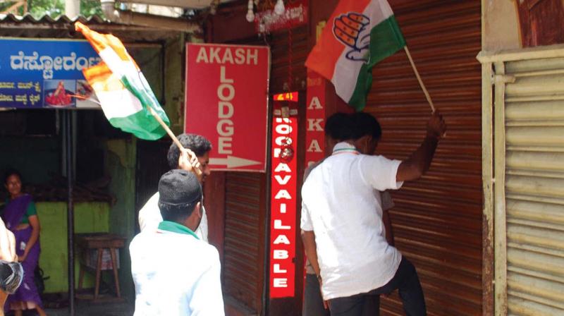 Congress workers forcibly shutting shops in  Mandya.