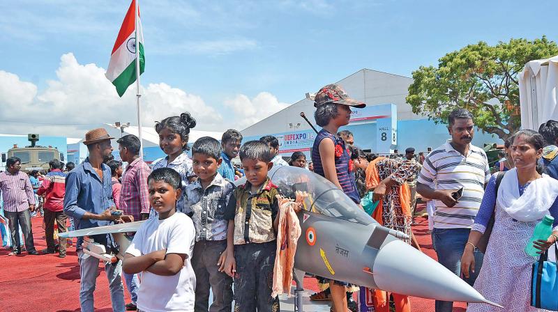 Children pose in front  of a flight model on display.  (Photo:DC)
