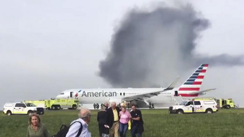 Passengers walk away from a burning American Airlines jet that aborted takeoff and caught fire on the runway at Chicagos OHare International Airport on Friday. (Photo: AP)