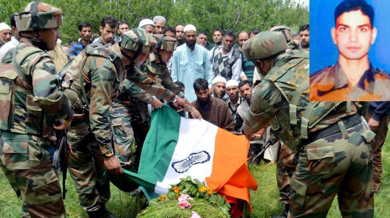 Army personnel paying tribute to the slain army officer Lt. Ummer Fayyaz (inset) during his funeral at his native village Sudsona in Kulgam district on Wednesday. (Photo: PTI)