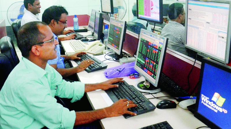 Brokers and shareholders at Kolkata share market react as Sensex and Nifty gain after opening on the first day on Monday following the launch of GST. (Photo: AP)