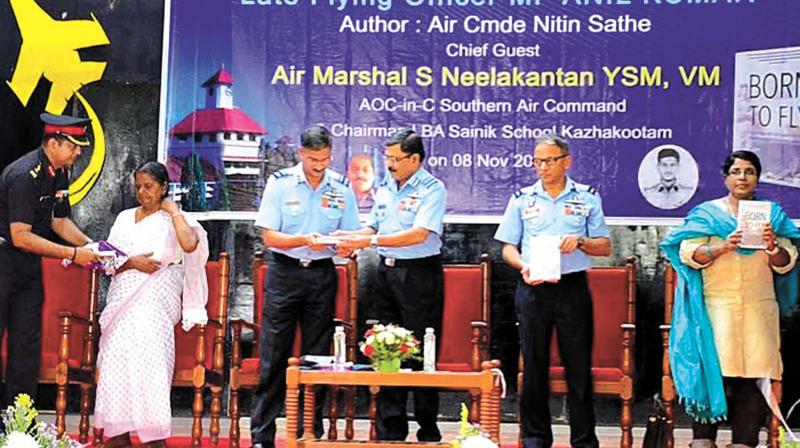 Air Marshal S. Neelakantan, Air Officer Commanding-in-Chief, Southern Air Command, hands over the biography Born to Fly to Air Commodore Nitin Sathe, Air Officer Commanding of Air Force Selection Board Mysore at Sainik School Kazhakkoottam in Thiruvananthapuram on Tuesday. Also seen are Col. A. Rajiv, SSK principal, S. M. Kamalamma, Air Vice-Marshal, G Amar Prasad Babu and Late M. P. Anil Kumars sister, M. P. Sheeja.