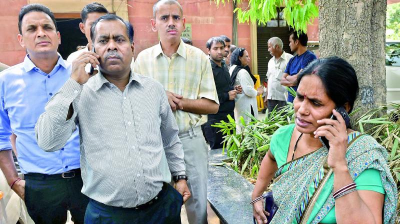 Nirbhayas parents talk on phone after the Supreme Courts judgement in New Delhi on Friday. (Photo: PTI)