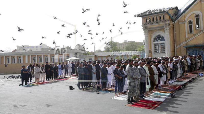 People attend Eid al-Fitr prayers outside of Shah-e-Dushamshera mosque in Kabul. Taliban, an insurgent group who fight against NATO and Afghanistans government, announced that they will start a 3-day ceasefire, starting in the first day of Eid al-Fitr. (Photo: AP)