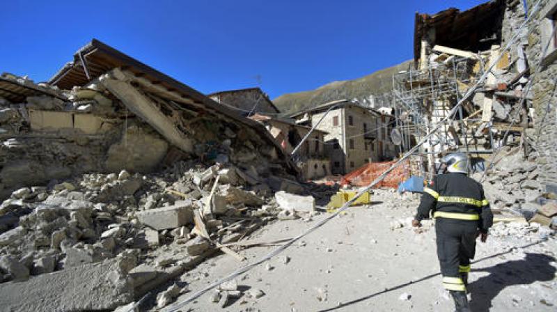 A firefighter walks past rubble in the village of Pretare, near Arquata del Tronto. (Photo: AP)