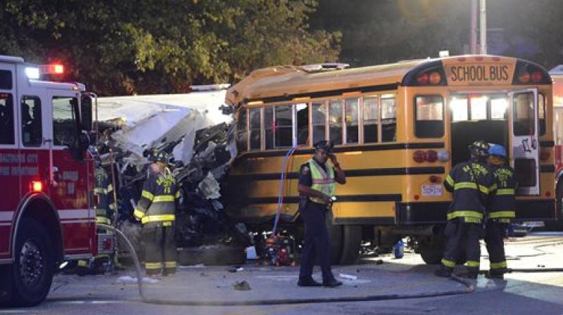 Fire department and rescue officials are at the scene of an early morning fatal collision between a school bus and a commuter bus. (Photo: AP)