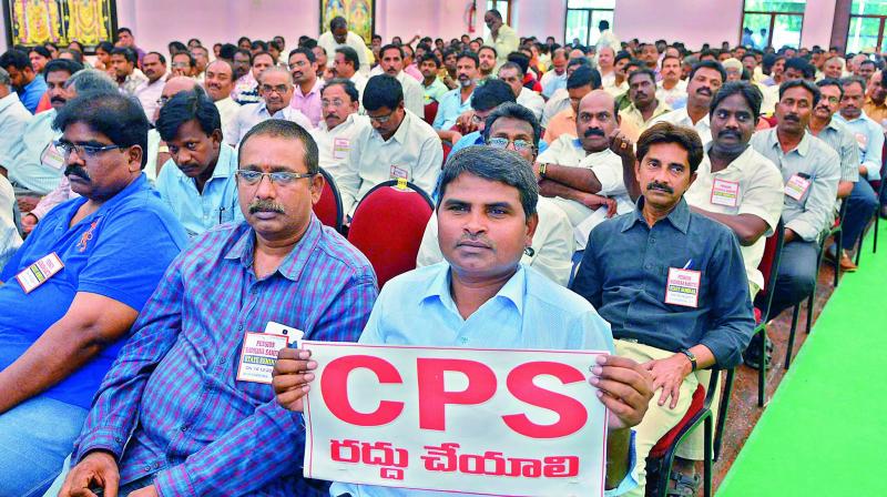 Employees display placards demanding scrapping the contributory pension scheme in Vijayawada on Saturday.