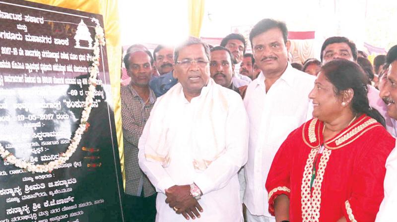 CM Siddaramaiah, BBMP Mayor G Padmavathi and others at the laying foundation for the works of storm water drain at at Laggere circle in Bengaluru on Friday KPN