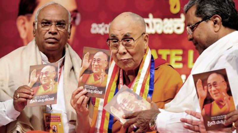 Tibetan spiritual leader the Dalai Lama with Ktaka CM Siddaramaiah and Congress MP Mallikarjun Kharge during a seminar on Social Justice and B R Ambedkar, in Bengaluru on Tuesday. (Photo: PTI)