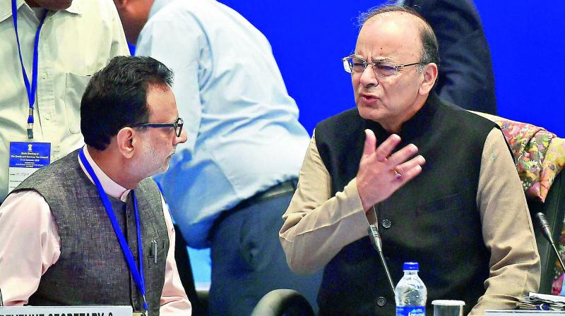 Union finance minister Arun Jaitley and revenue secretary Hasmukh Adhia at the 6th Goods and Services Tax Council meeting in New Delhi on Sunday. (Photo: AP)