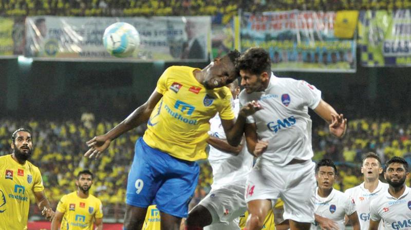 Kerala Blasters Kervens Belfort (left) and Marcos Tebar of Delhi Dynamos vie for the ball in their ISL-3 semi-final first leg match in Kochi on Sunday. The hosts won 1-0 (Photo: SUNOJ NINAN MATHEW)