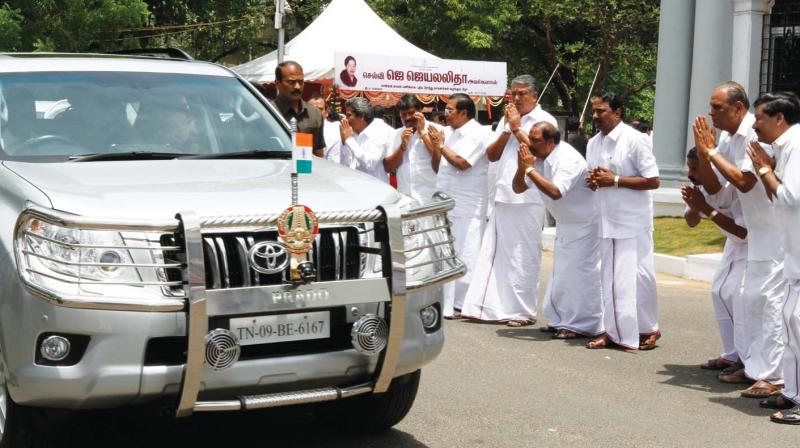 File photo of AIADMK cadres bowing down to Jayalalithaa as her car passes by (Photo: DC)