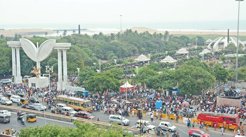 Large stream of people continue to throng J. Jayalalithaas burial site inside MGR memorial at Marina beach on Sunday (Photo: DC)