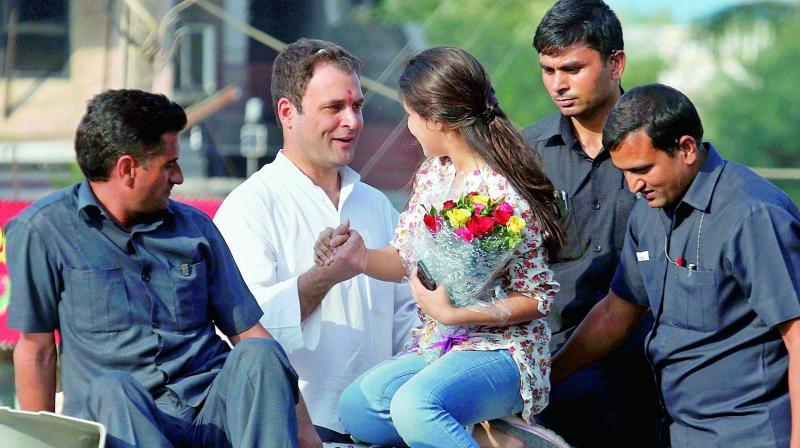 Congress vice-president Rahul Gandhi being greeted by a young supporter in Bharuch on Wednesday. (Photo: PTI)