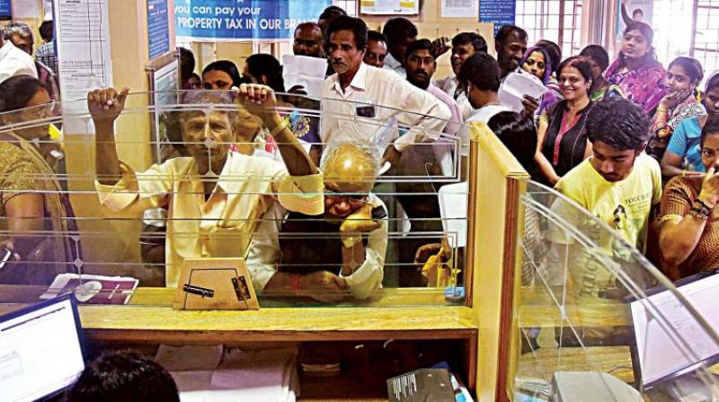 People wait for their turn to exchange demonitised currency notes at a bank. (Photo: DC)