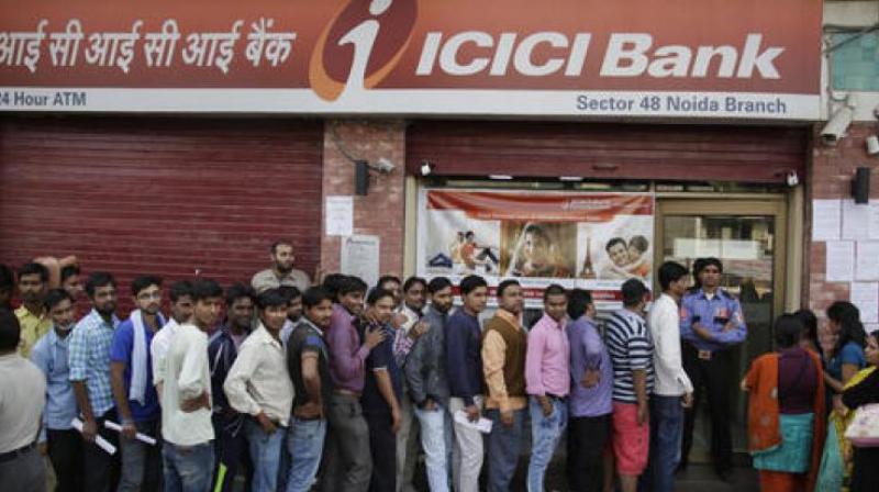 People stand in a queue to deposit and exchange discontinued currency notes. (Photo: PTI)