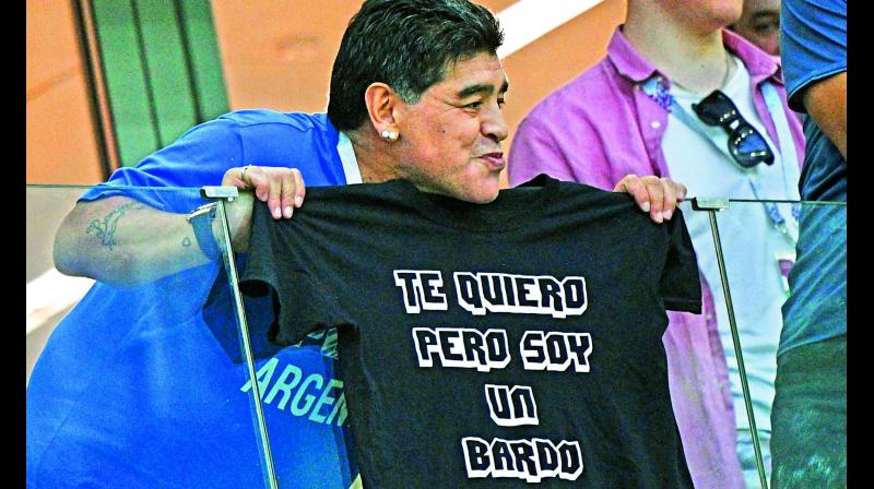 Diego Maradona poses with a T-shirt reading \I love you but Im a mess\ from the grandstand during the match between Argentina and Croatia.  (Photo:AFP)