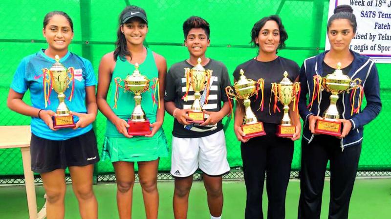 Winners and runners-up of the womens events at the Telangana State Tennis Association AITA Ranking Tennis Tournament pose with their trophies at the SATS Tennis Complex in Lal Bahadur Stadium, Hyderabad on Friday.