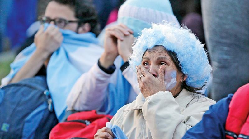 Argentina fans react in disbelief at the end of a televised broadcast of the Croatia vs. Argentina World Cup soccer match, in Buenos Aires, Argentina, on Thursday. (Photo:AP)