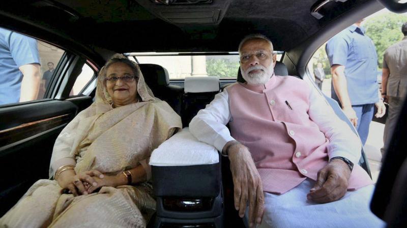 Prime Minister Narendra Modi with his Bangladeshi counterpart Sheikh Hasina travel together to Manekshaw centre to meet Indian Soldiers who fought in 1971 war, in New Delhi. (Photo: PTI)