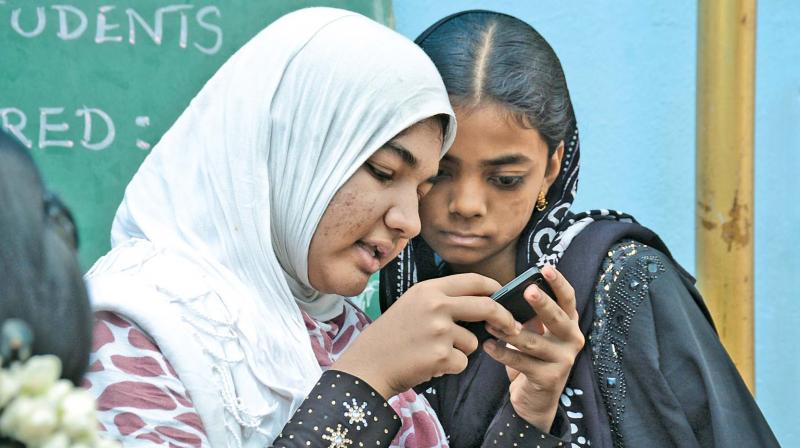 Students browsing through results on their phone. (Photo: DC)