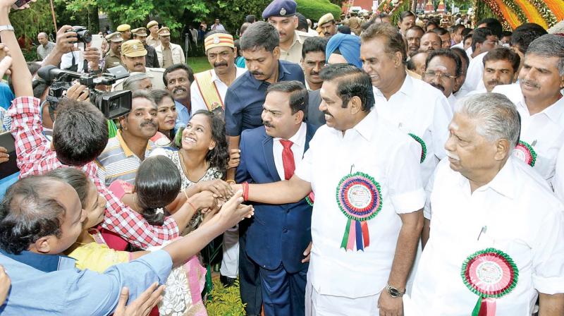 Chief Minister Edappadi K. Palanisami takes a selfie with visitors at the flower show at Govt. Botanical Garden in Ooty on Friday. (Photo: DC)