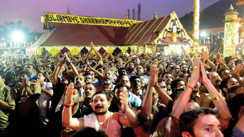Devotees of Swamy Ayyappa ecstatic on seeing the Makaravillaku at Sabarimala on Saturday	(Photo:DC)