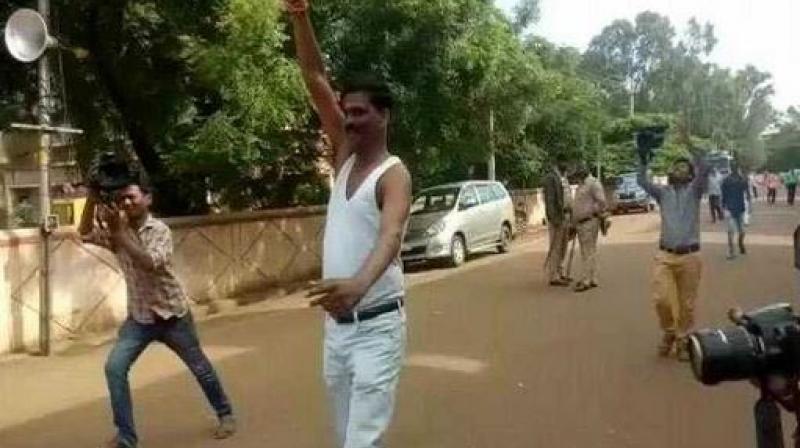 BJPs Veerappa Siragannavar takes off his shirt to celebrate his victory in Karnataka urban local body polls. (Photo: Screengrab | ANI)