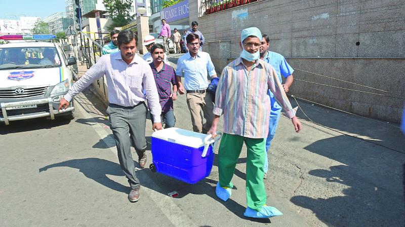 A team rushes with a donated liver to an ambulance that was parked on the other side of the road at Care Hospital, Banjara Hills.