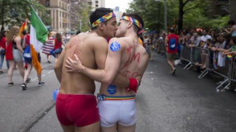 A couple kisses as they participate in the Heritage Pride March in New York. (Photo: AP)
