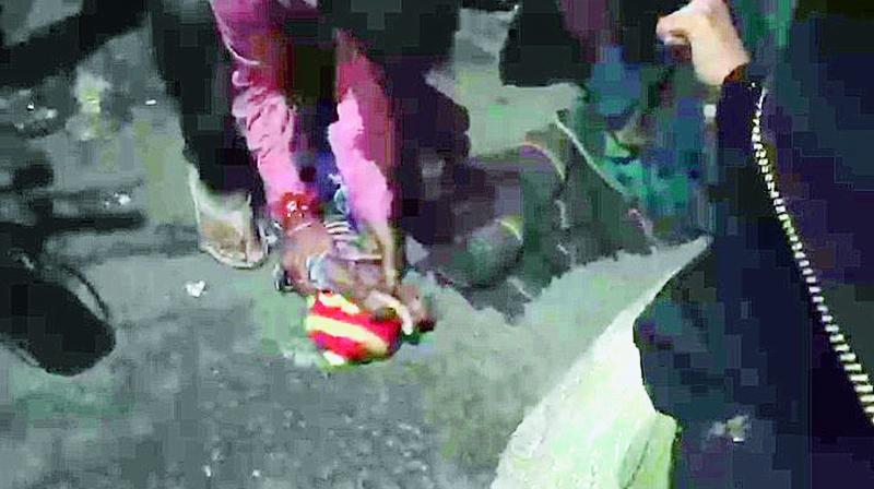 A screenshot of a video shows the nine-month-old baby being lifted from the Mehendipatnam main road late on Monday.