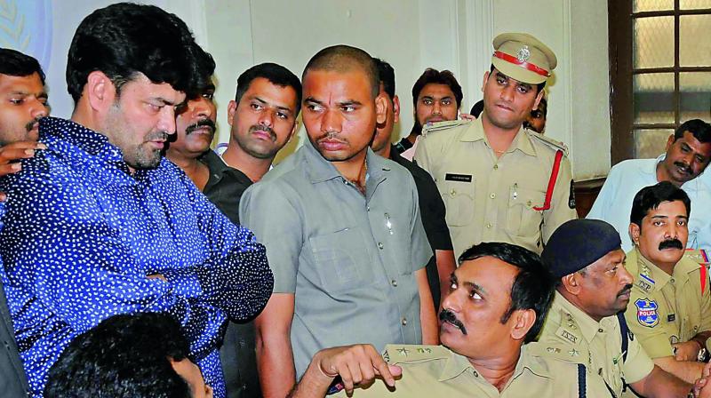 South Zone DCP V Satyanarayana speaks to Ayub Khan during a press meet on Tuesday. (Photo: DC)